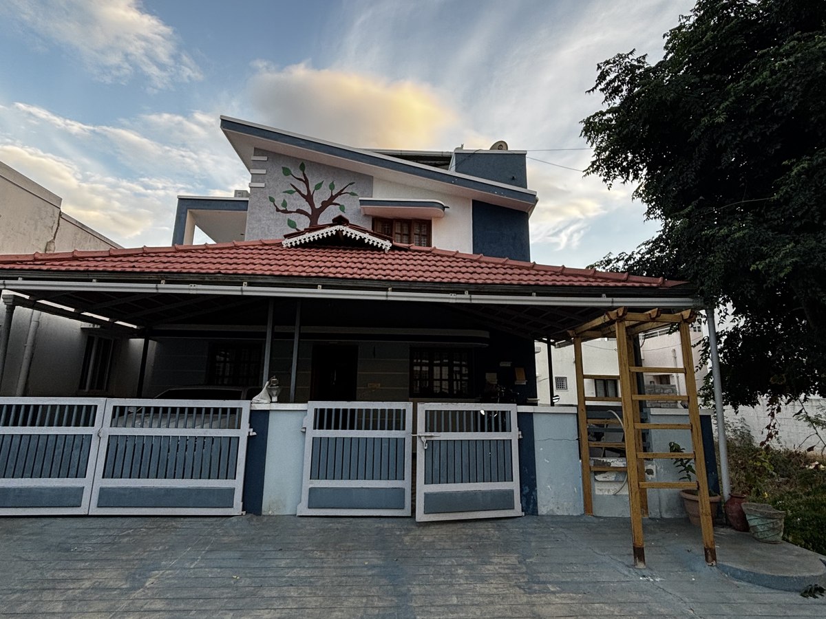 The completed home with its roofed verandah, gates and laid driveway, handed over by Lakshmi Builders — in Pannimadai, Coimbatore